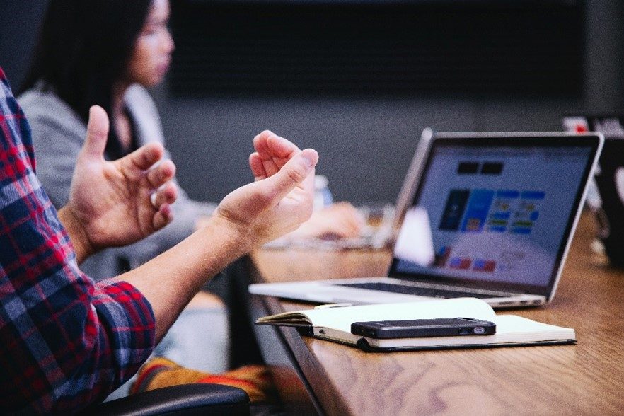 SAFE3 Hände in diskutierender Haltung vor Arbeitssetting